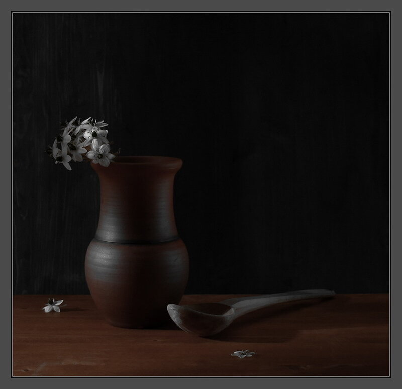 Vase with flowers and spoon