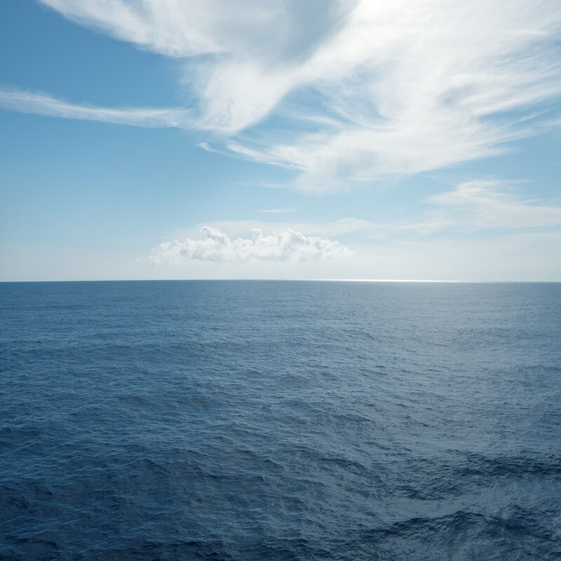 Vast ocean under a cloudy sky
