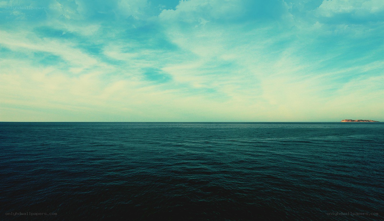 Vast ocean under cloudy sky