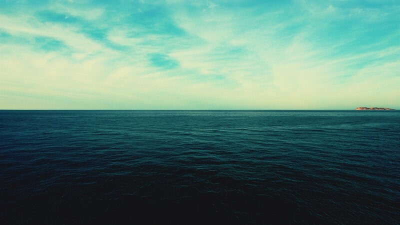 Vast ocean with distant island