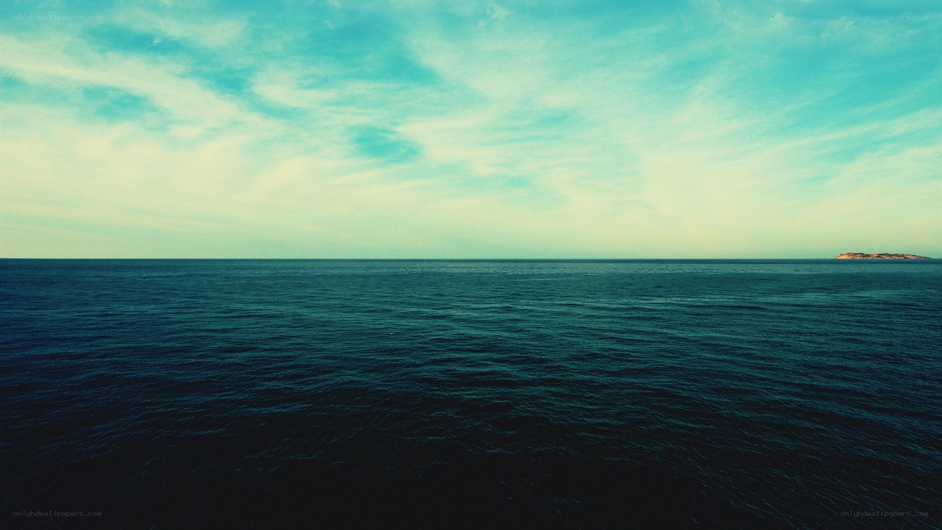 Vast ocean with distant island