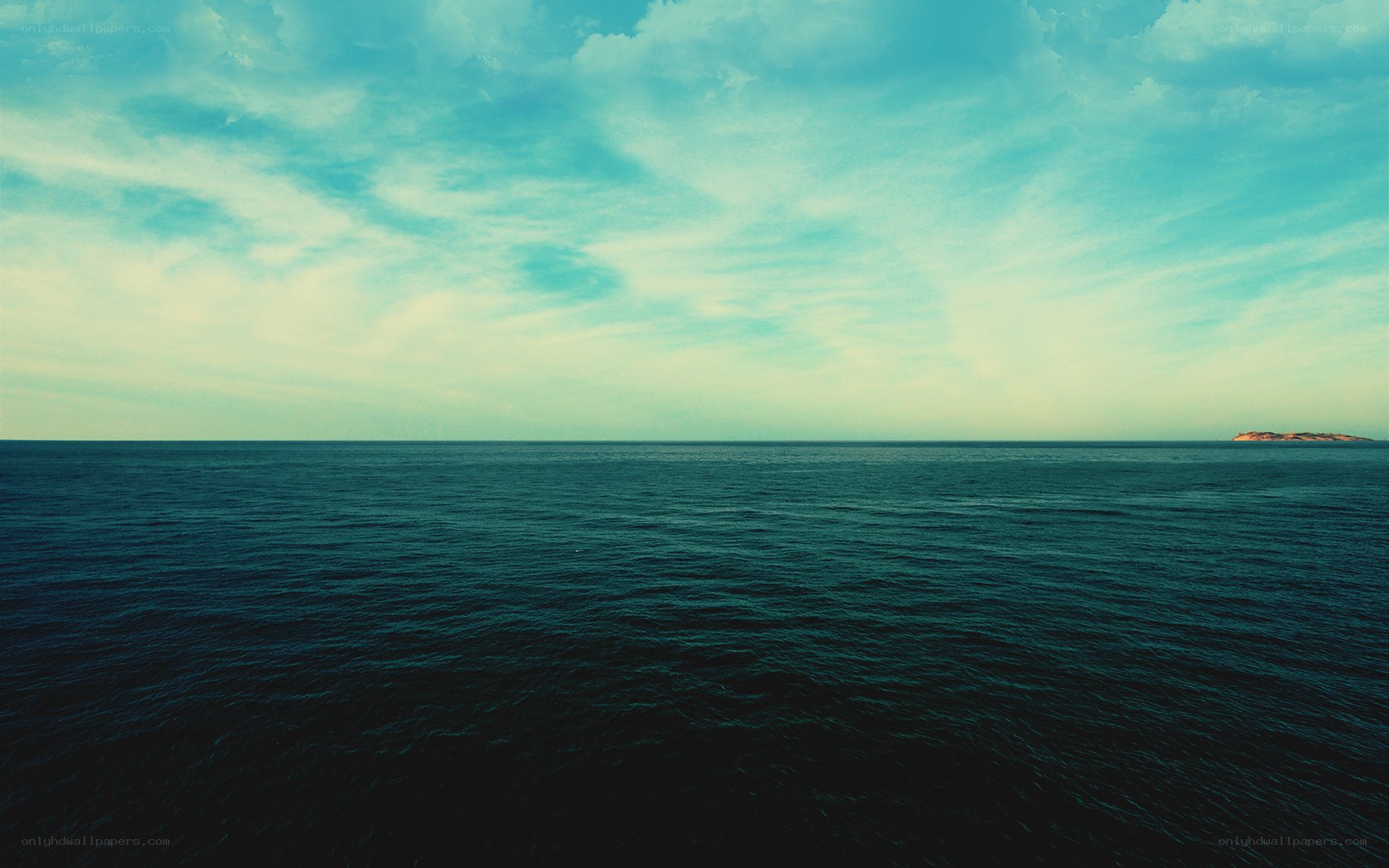 Vast ocean with distant island