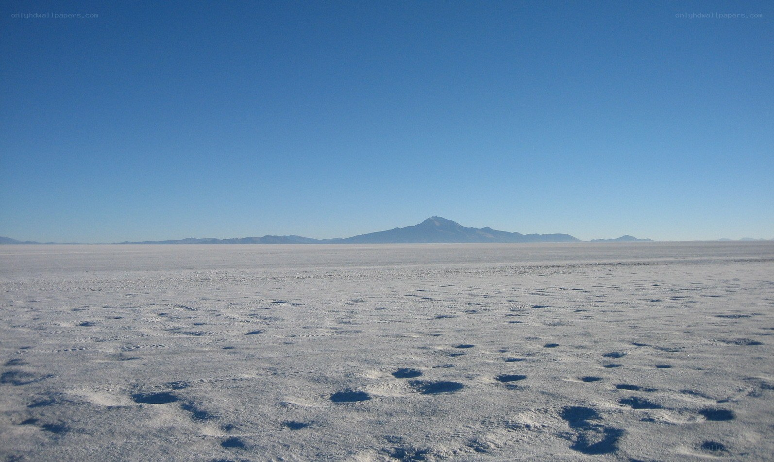 vast salt flat with mountain