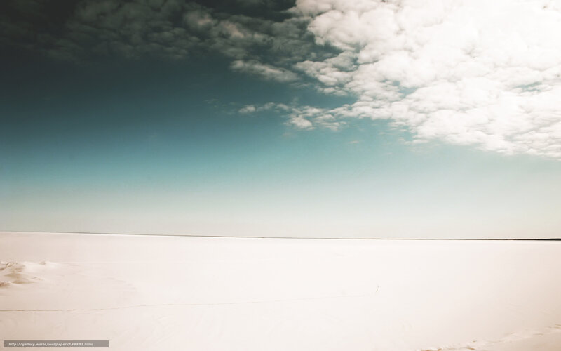 Vast white salt flat under cloudy sky