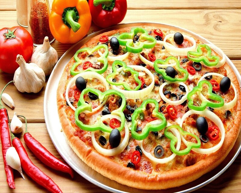 Vegetable pizza on wooden table