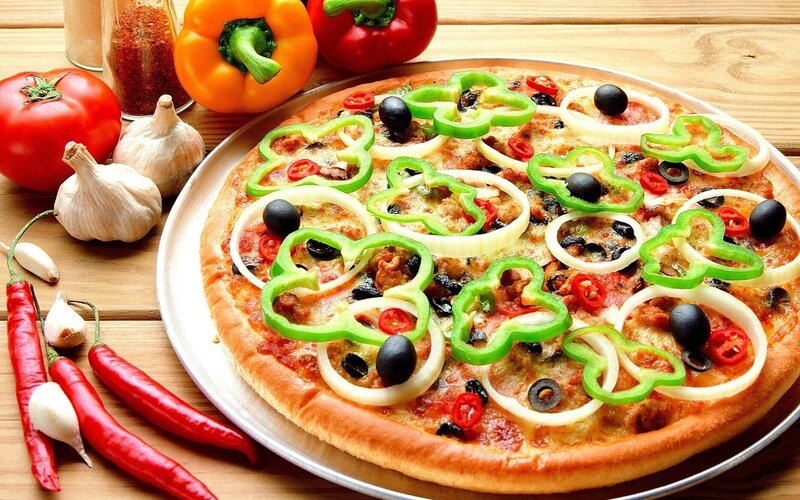 vegetable pizza on wooden table
