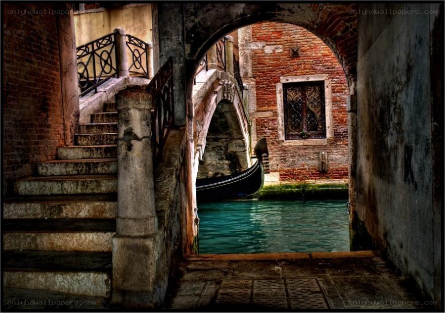 Venetian canal under archway
