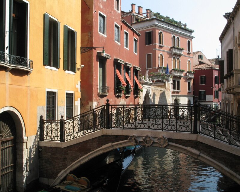 Venetian canal with gondola and bridge