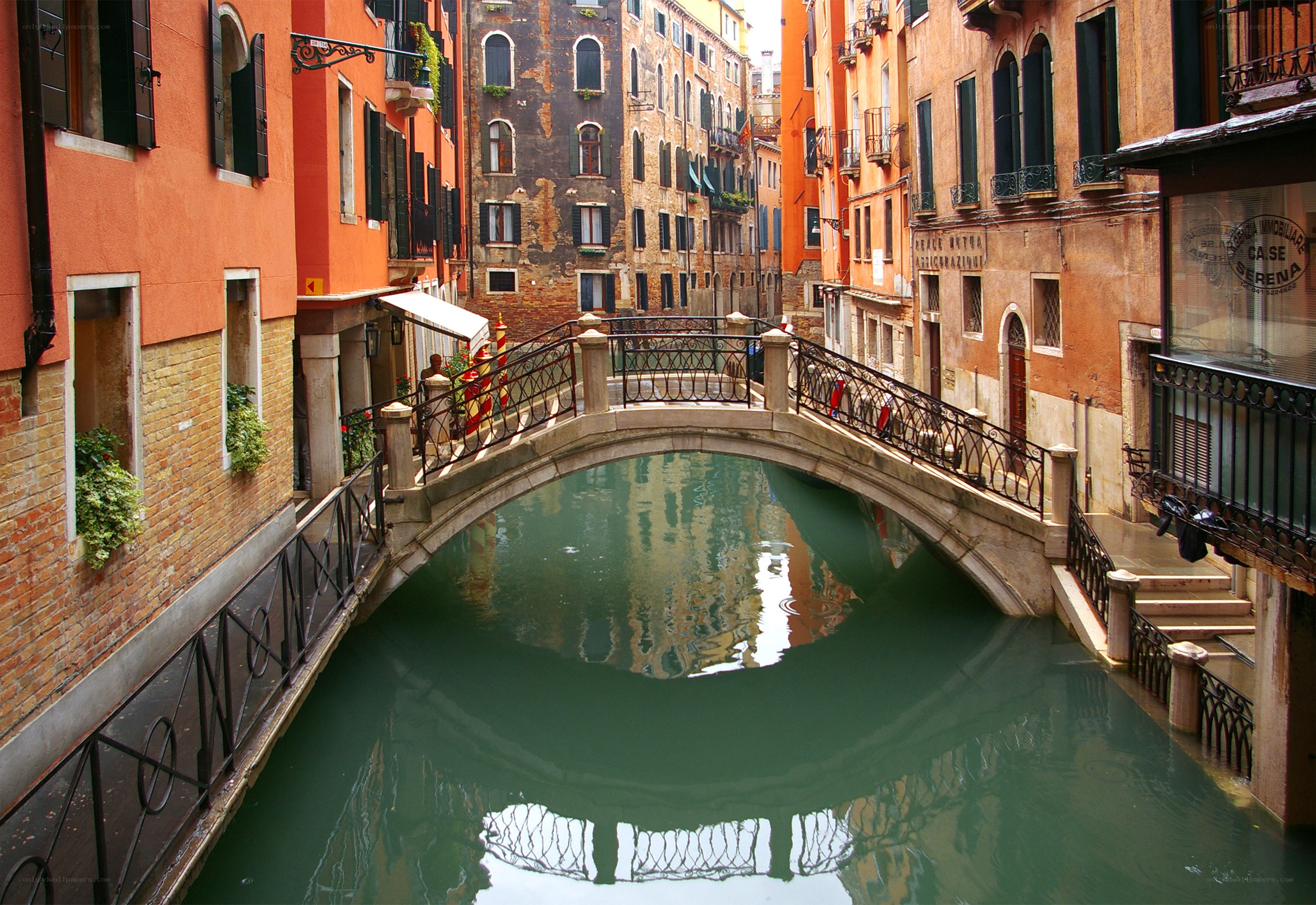 Venetian canal with stone bridge