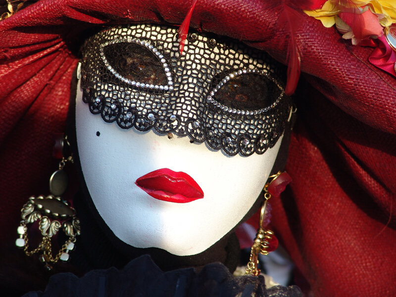 Venetian mask with red hat