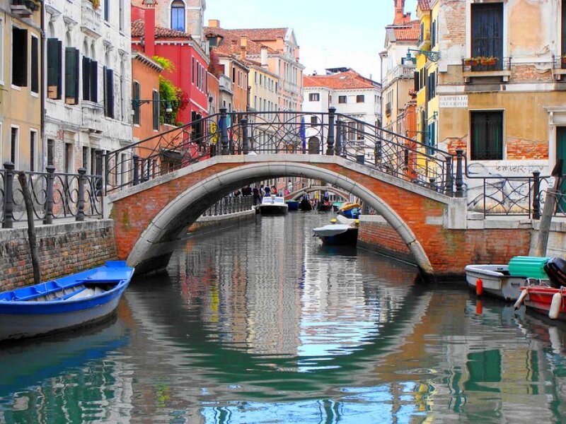 Venice canal with arched bridge
