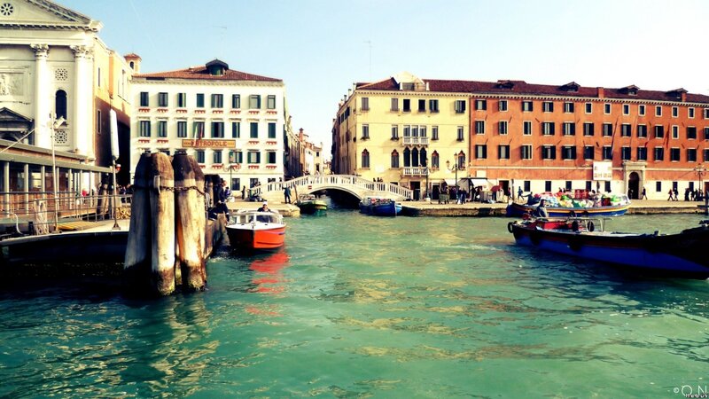 Venice canal with boats and bridge