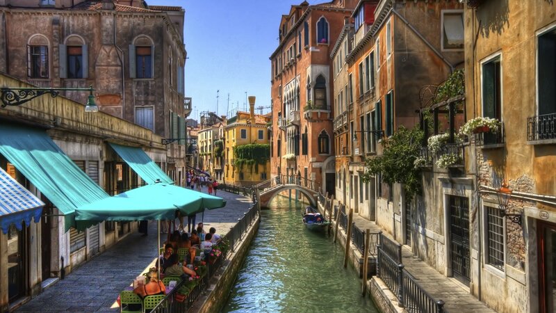 Venice canal with gondola and cafes