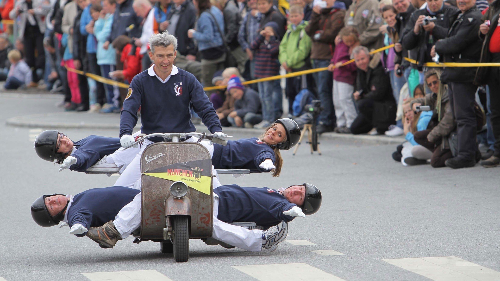 Vespa stunt performance with riders