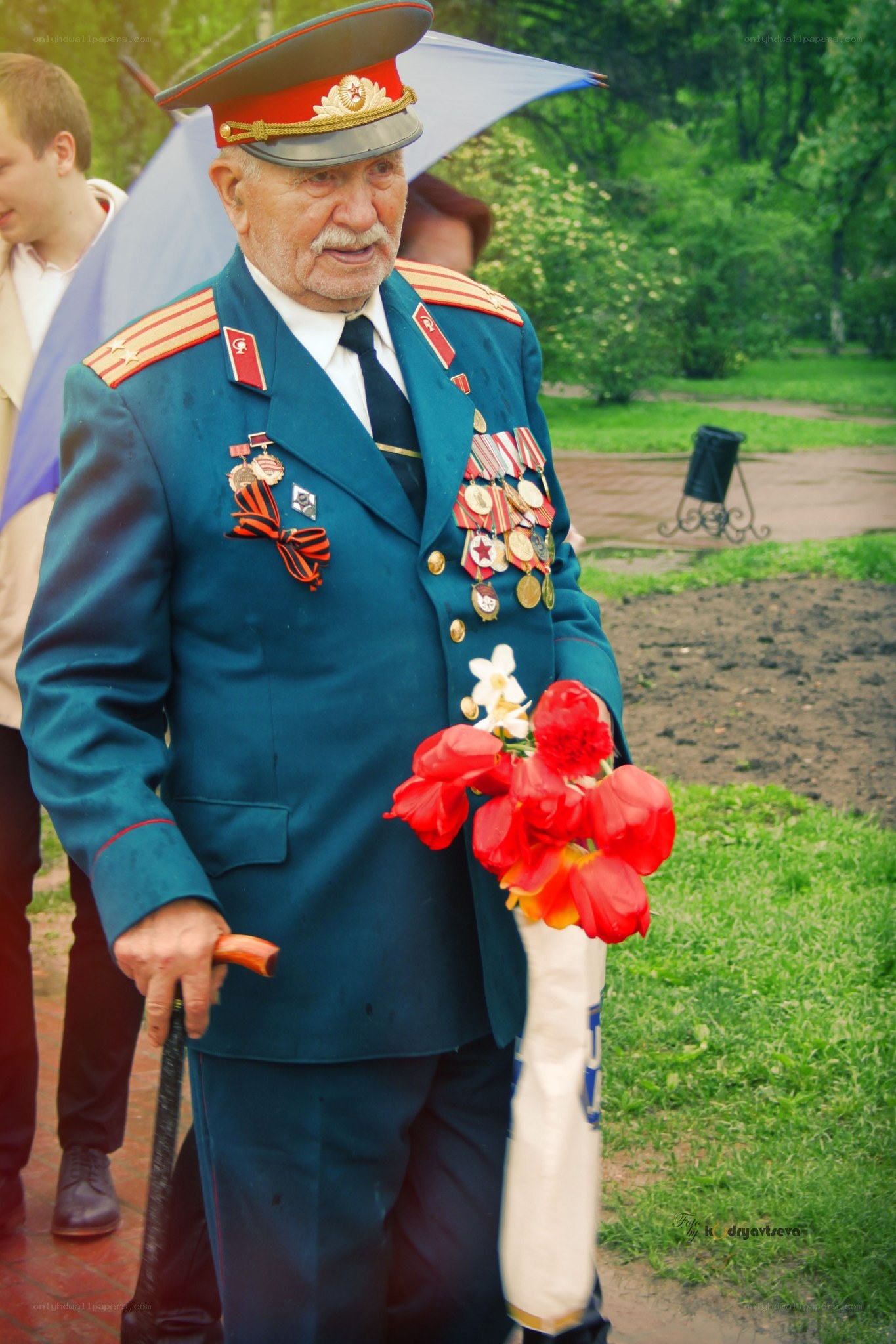 Veteran in uniform with flowers