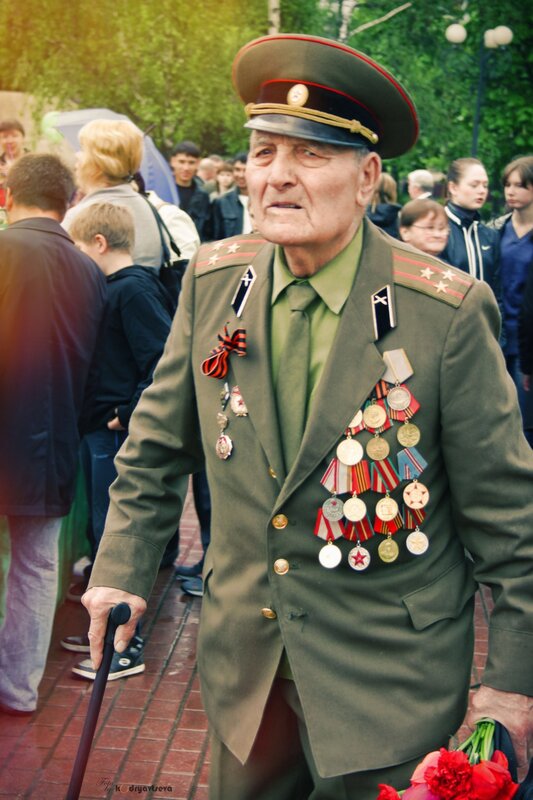 Veteran with medals and flowers