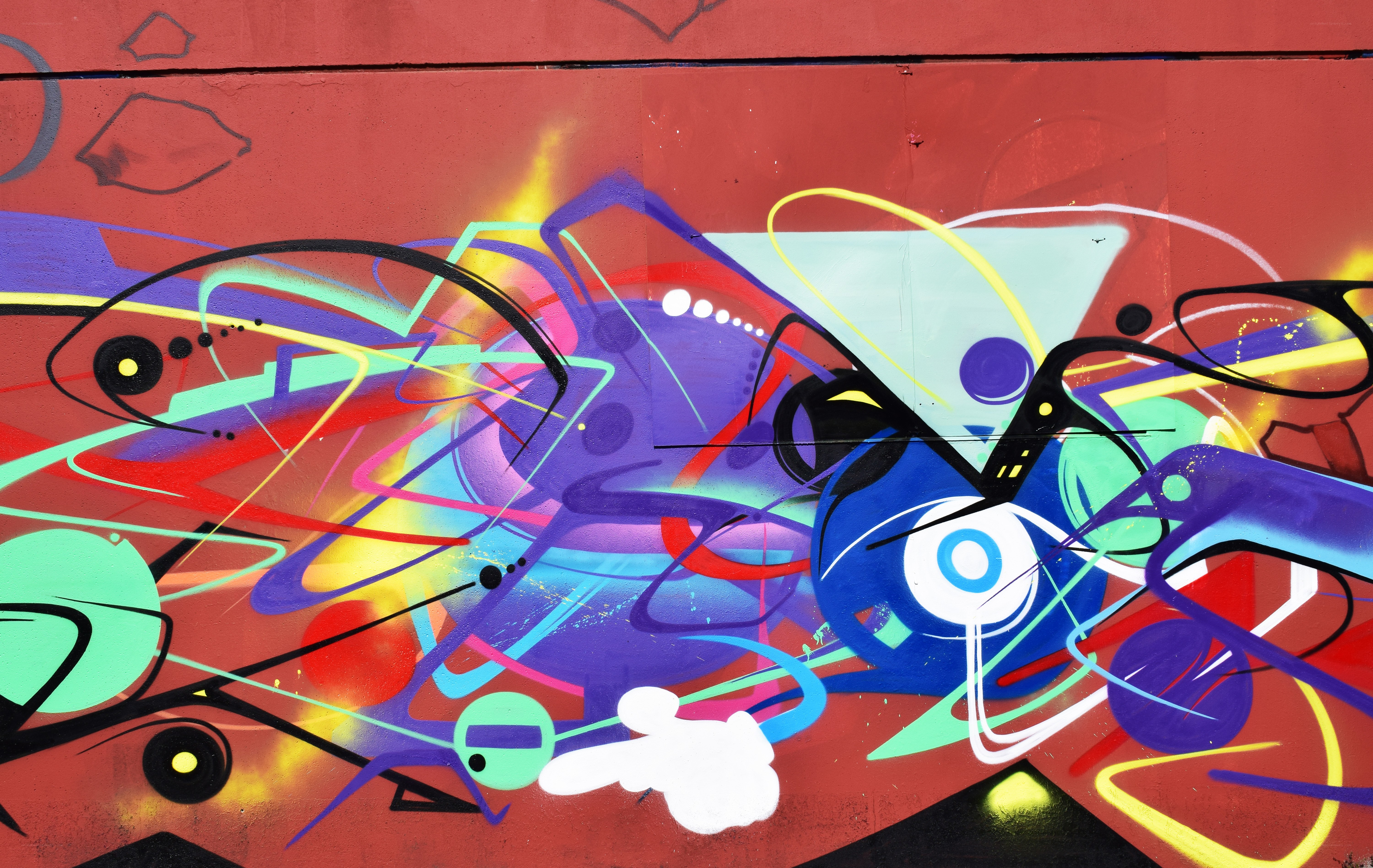 vibrant graffiti art on red wall