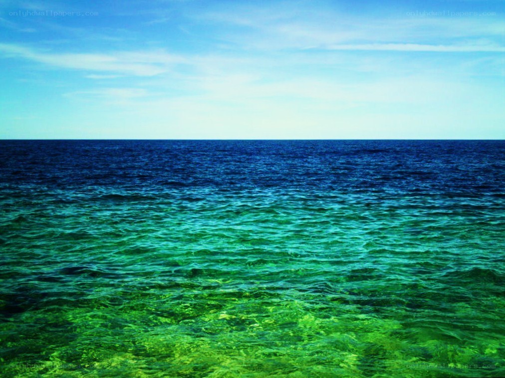 Vibrant ocean waters under blue sky