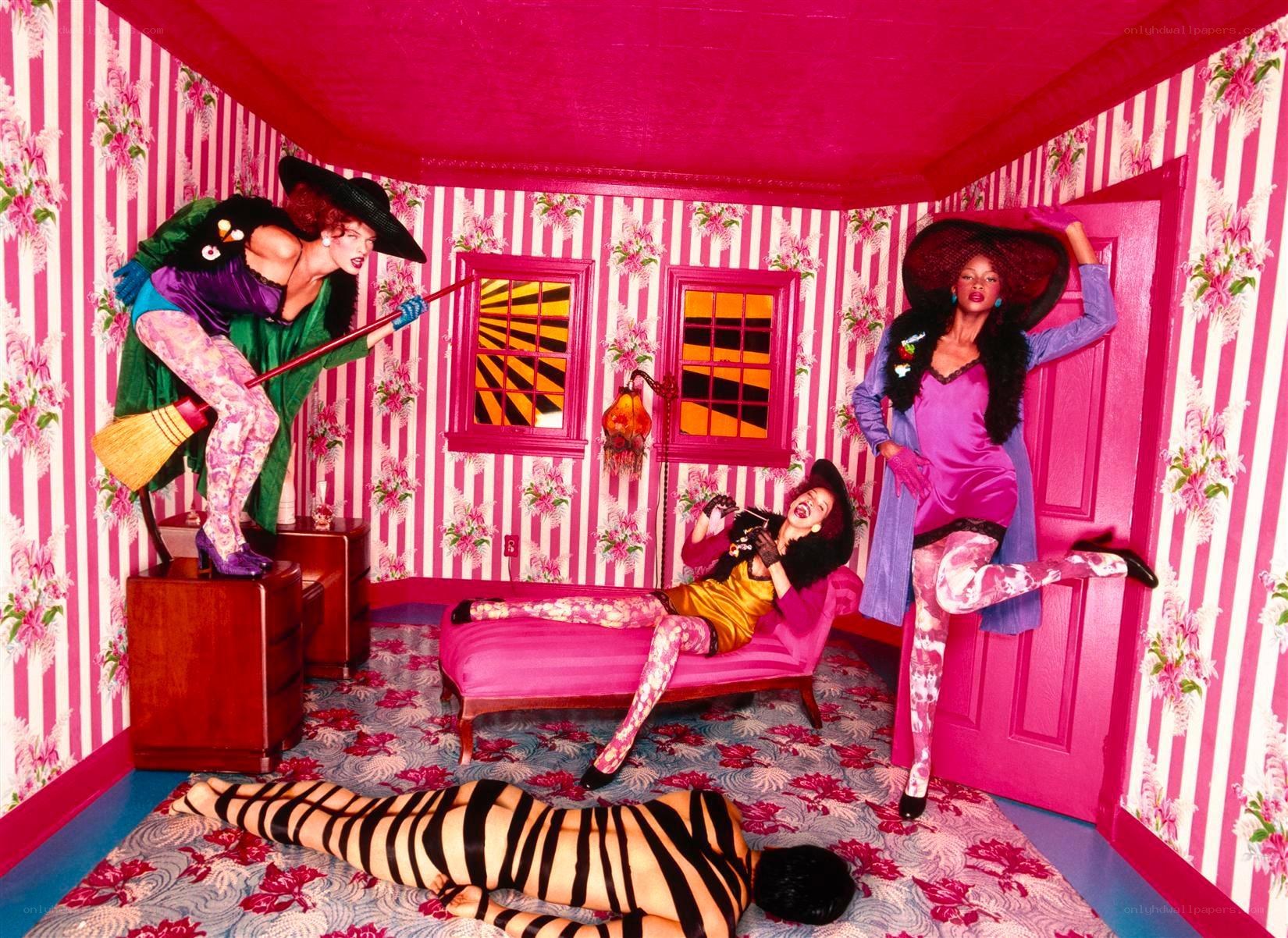Vibrant pink room with costumed figures