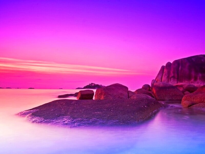 vibrant purple sunset over rocks