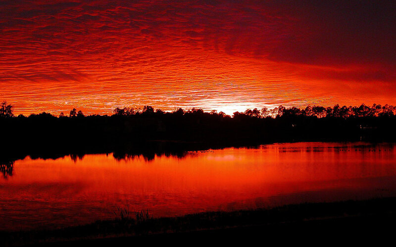Vibrant red sunset over lake
