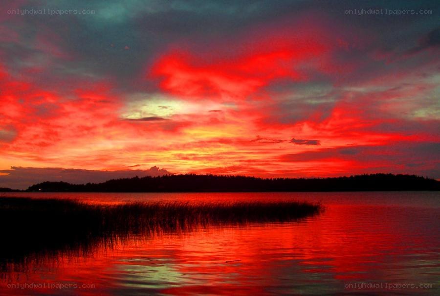 Vibrant red sunset over lake