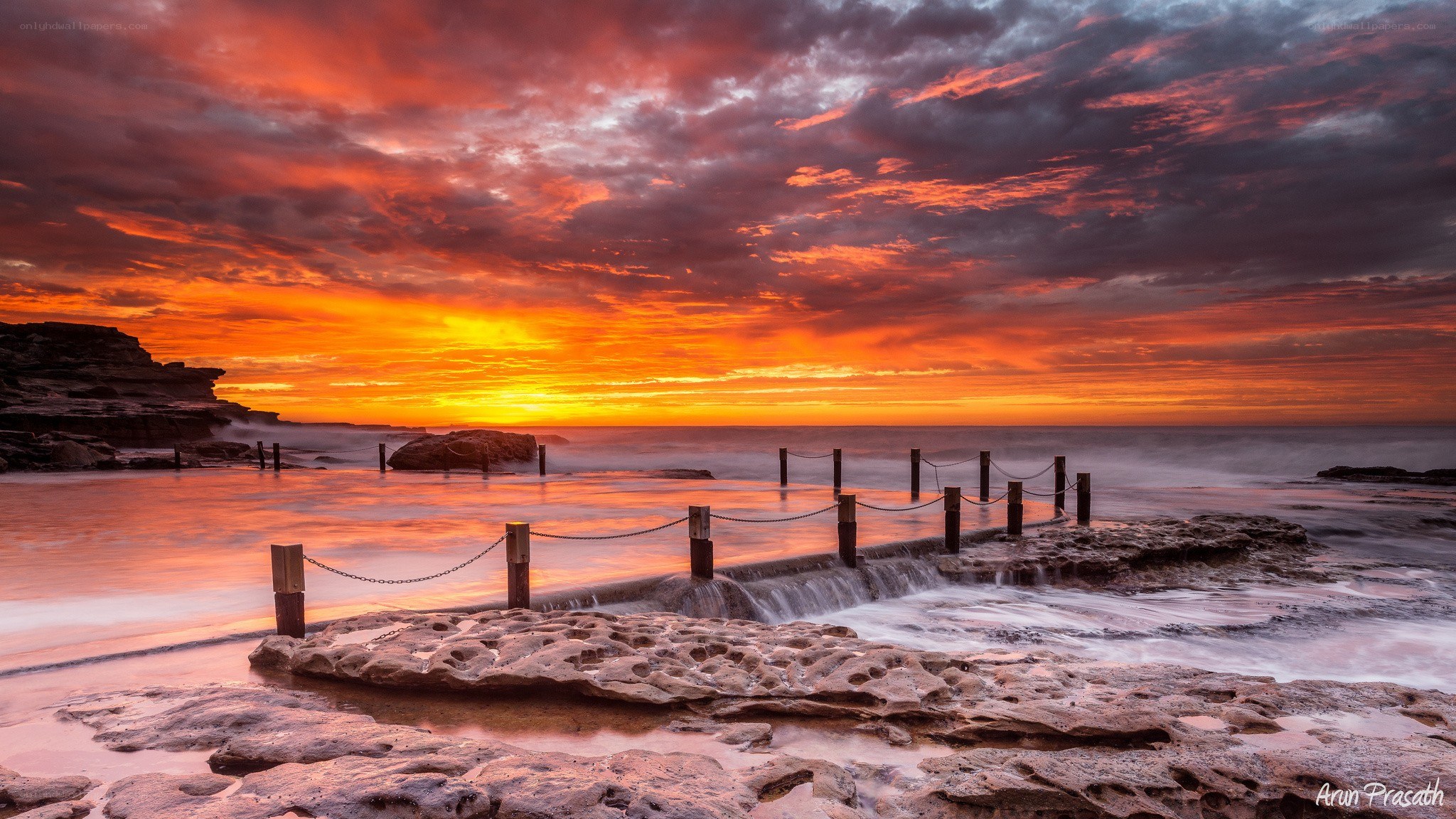 Vibrant sunset at coastal rock pool