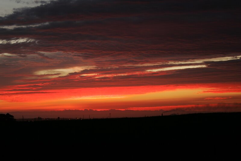 Vibrant sunset over a dark landscape