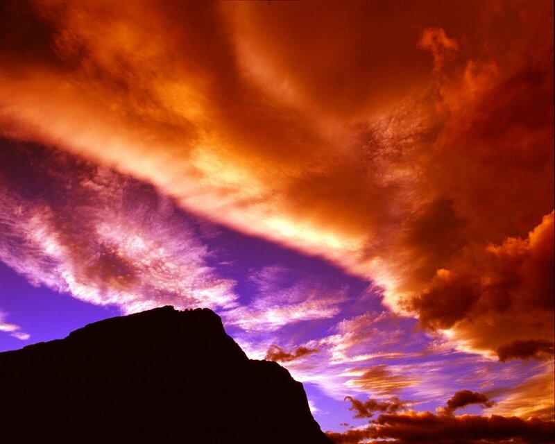 Vibrant sunset over a mountain silhouette