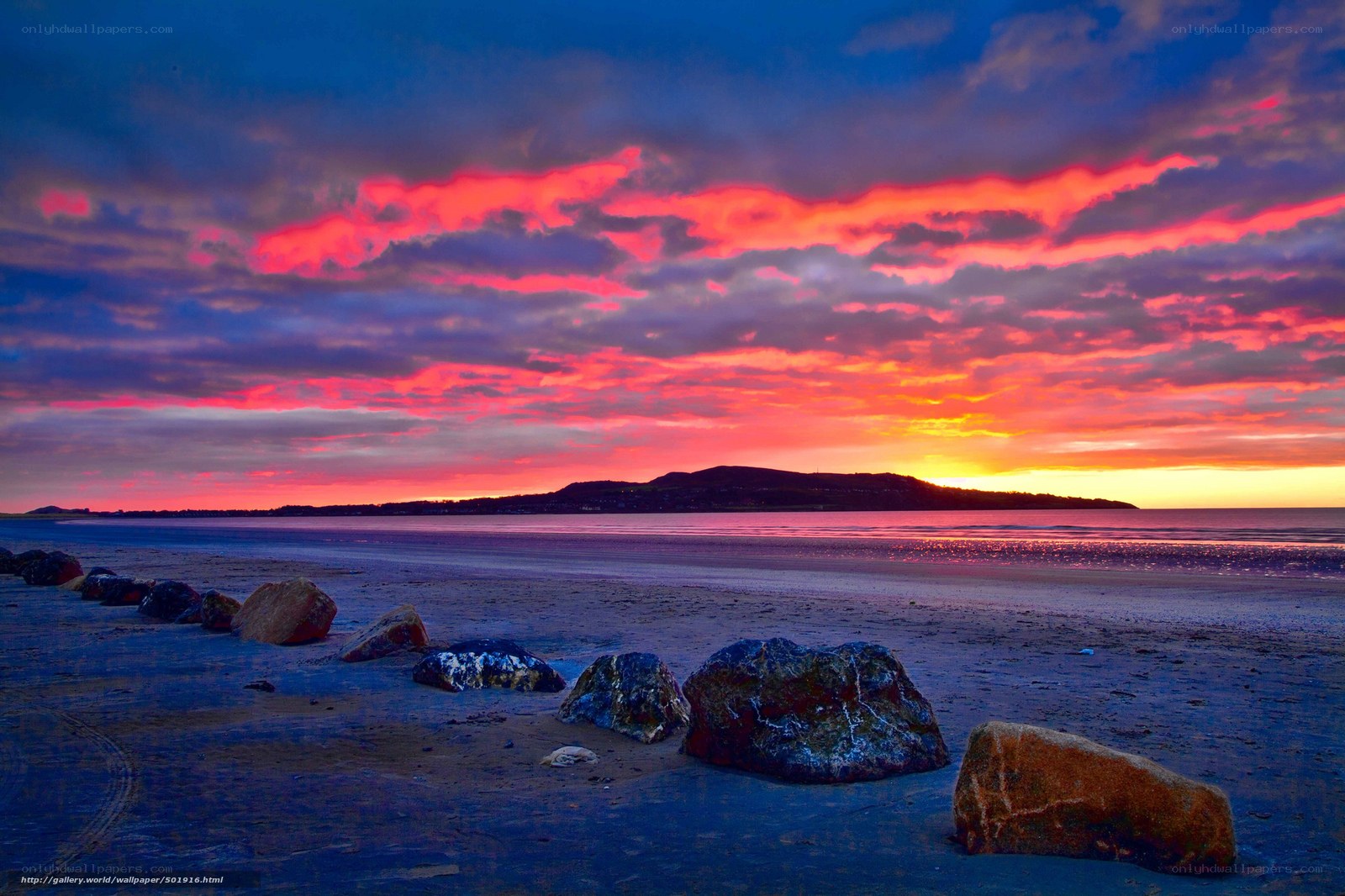 Vibrant sunset over a rocky beach