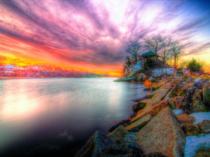 Vibrant sunset over a rocky lakeside