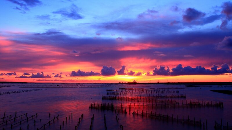 Vibrant sunset over aquaculture farms