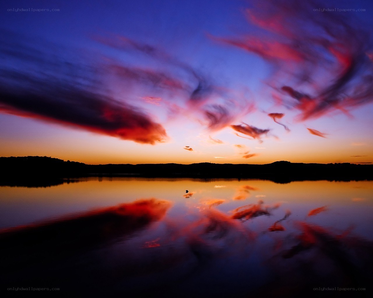 Vibrant sunset over calm lake