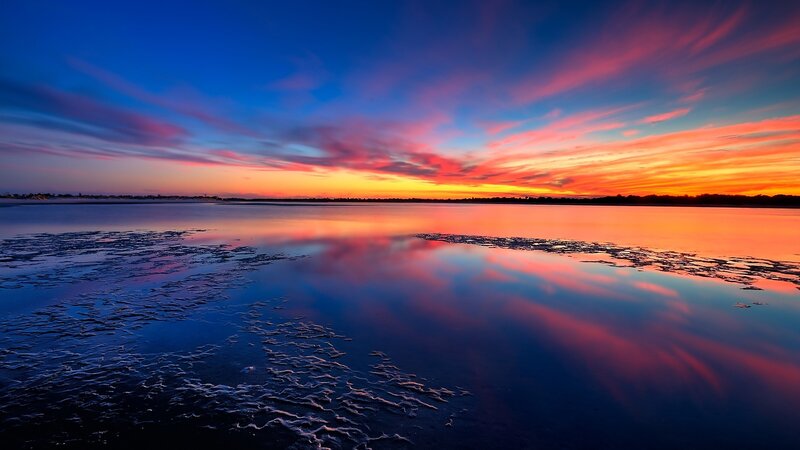 Vibrant sunset over calm water