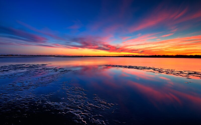 Vibrant sunset over calm water