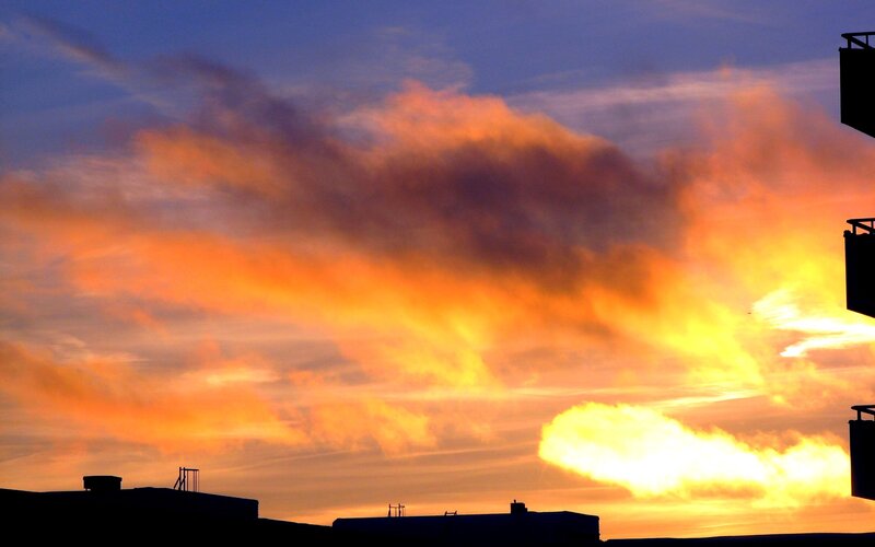 Vibrant sunset over city rooftops