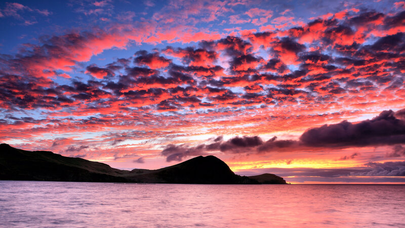 Vibrant sunset over coastal hills
