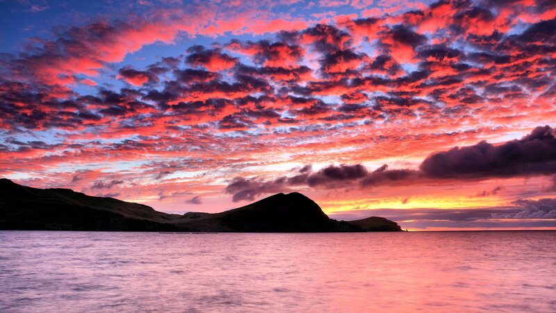 Vibrant sunset over coastal hills