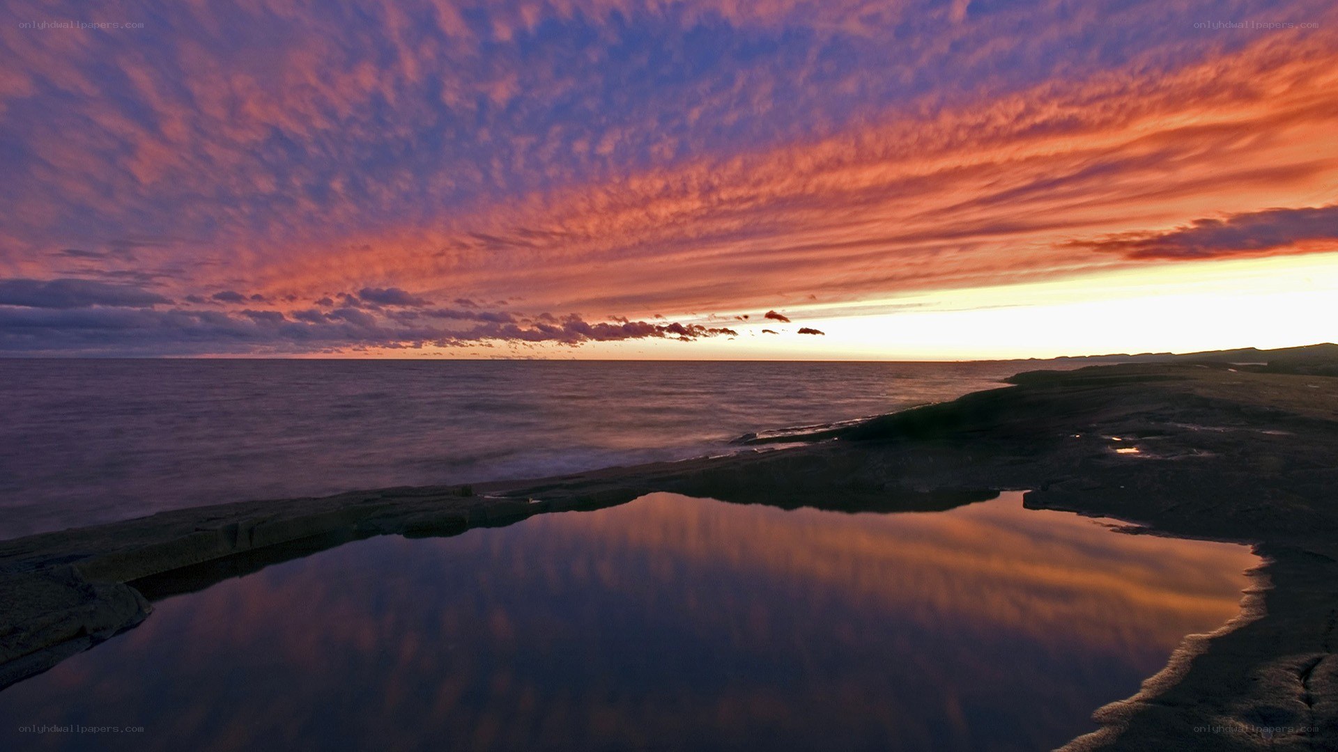 vibrant sunset over coastal rocks