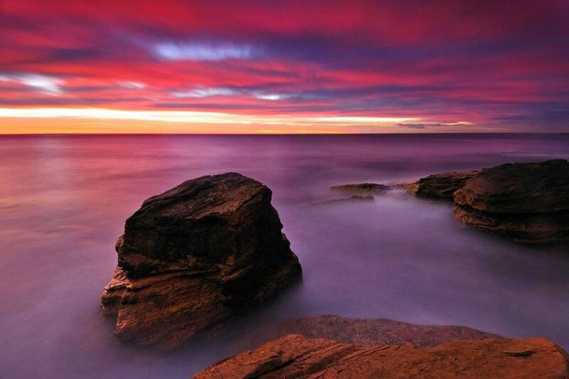 Vibrant sunset over coastal rocks
