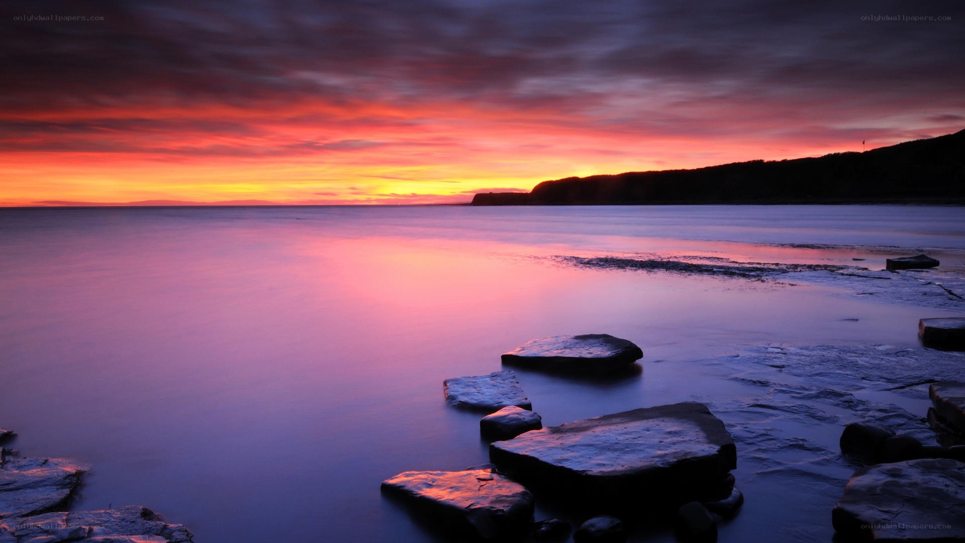 Vibrant sunset over coastal rocks