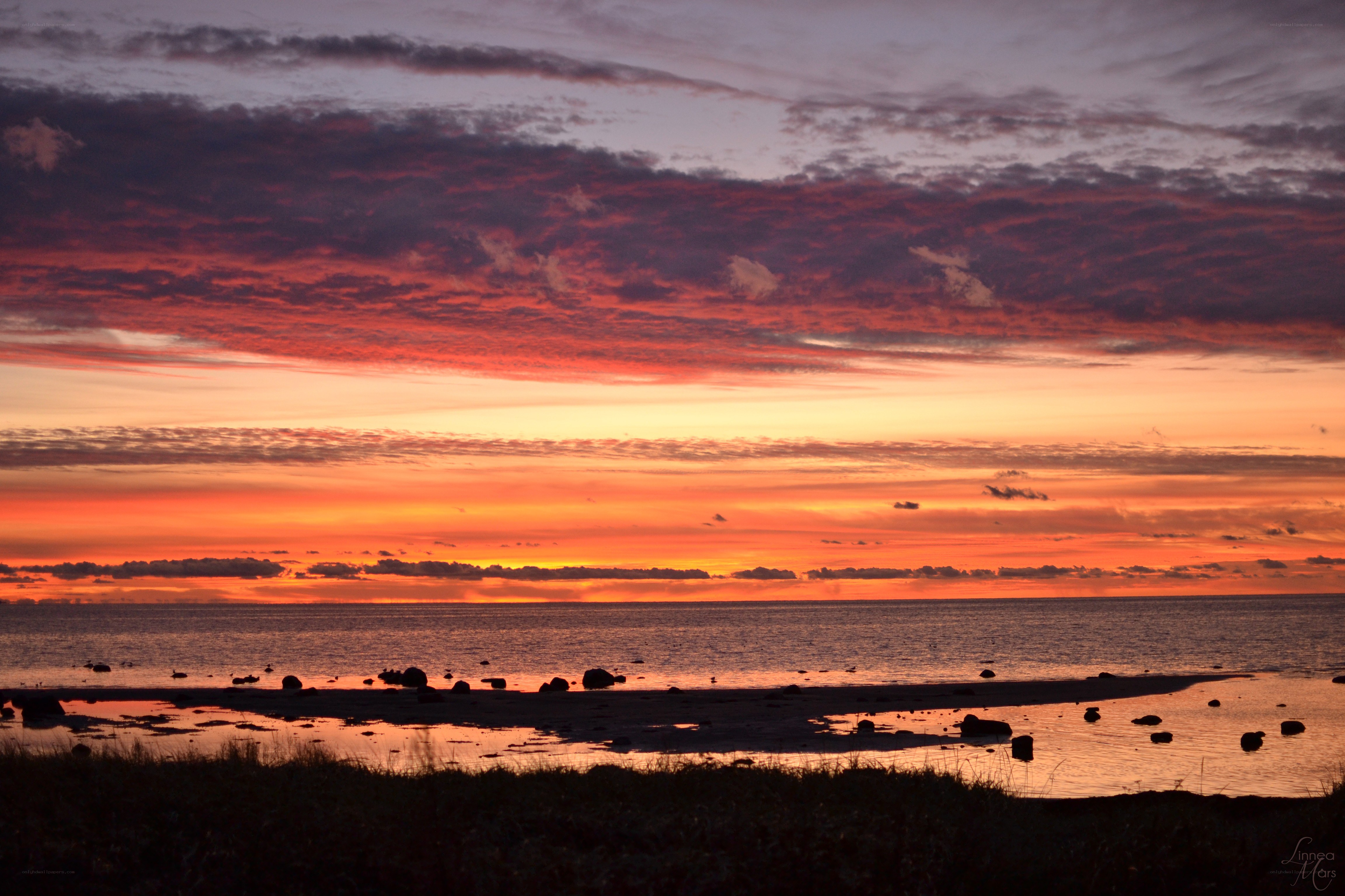 Vibrant sunset over coastal rocks
