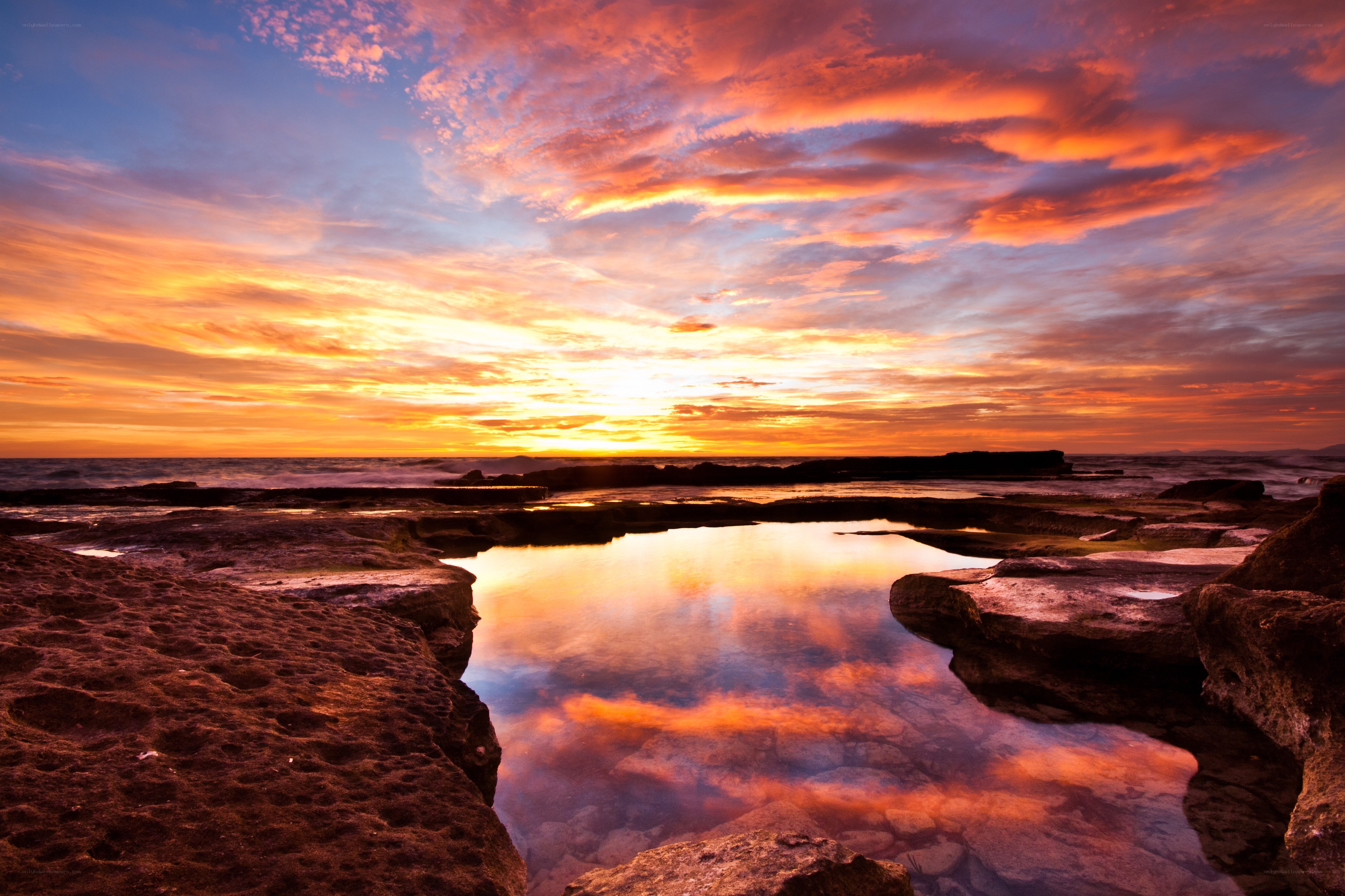 Vibrant sunset over coastal rocks