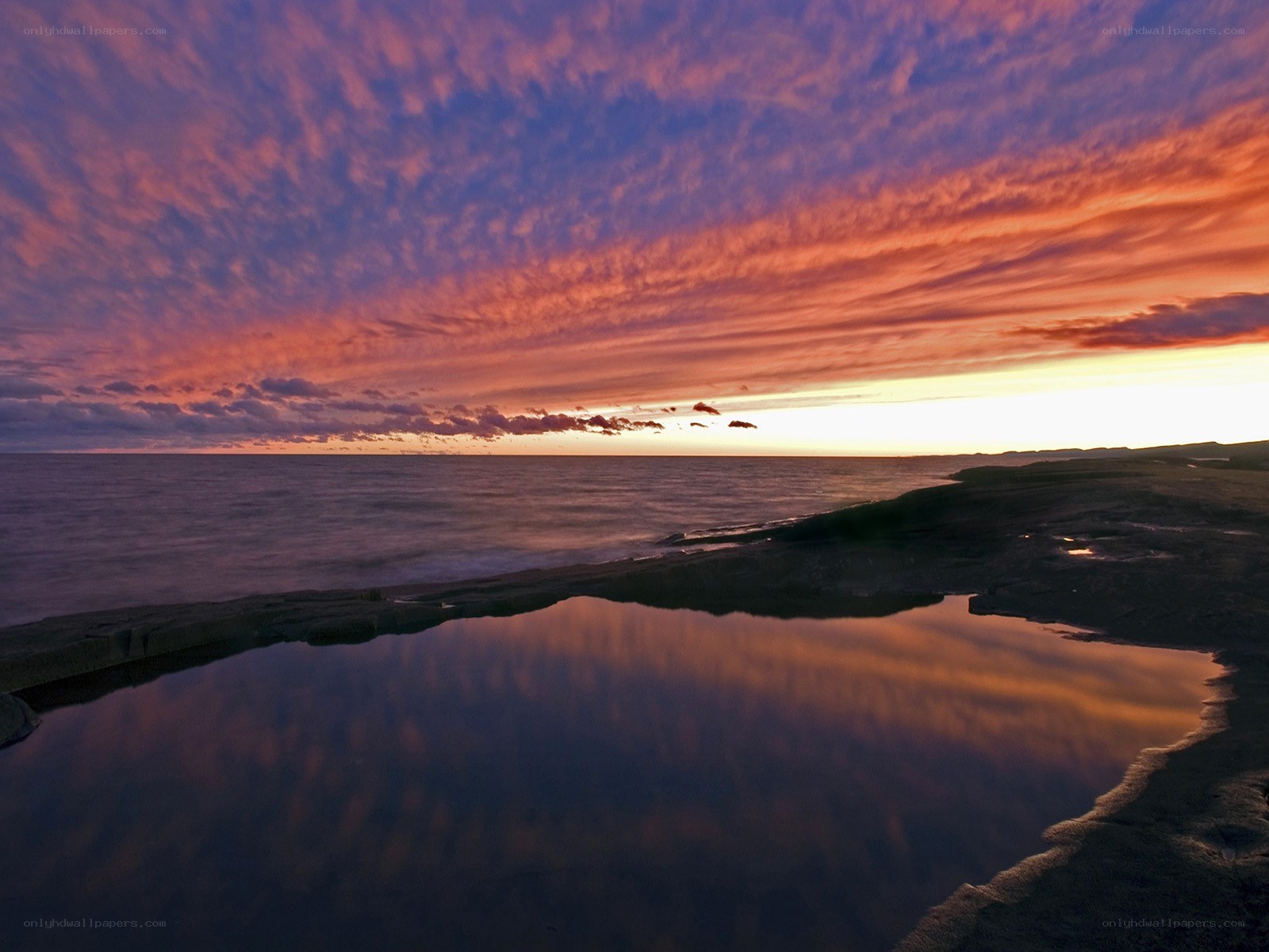 Vibrant sunset over coastal rocks