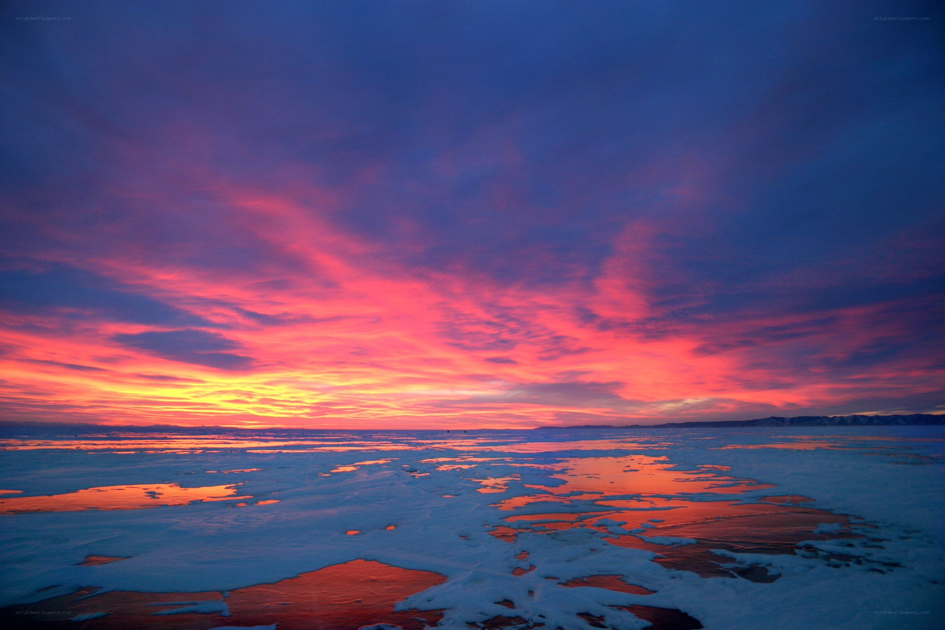 Vibrant sunset over frozen lake