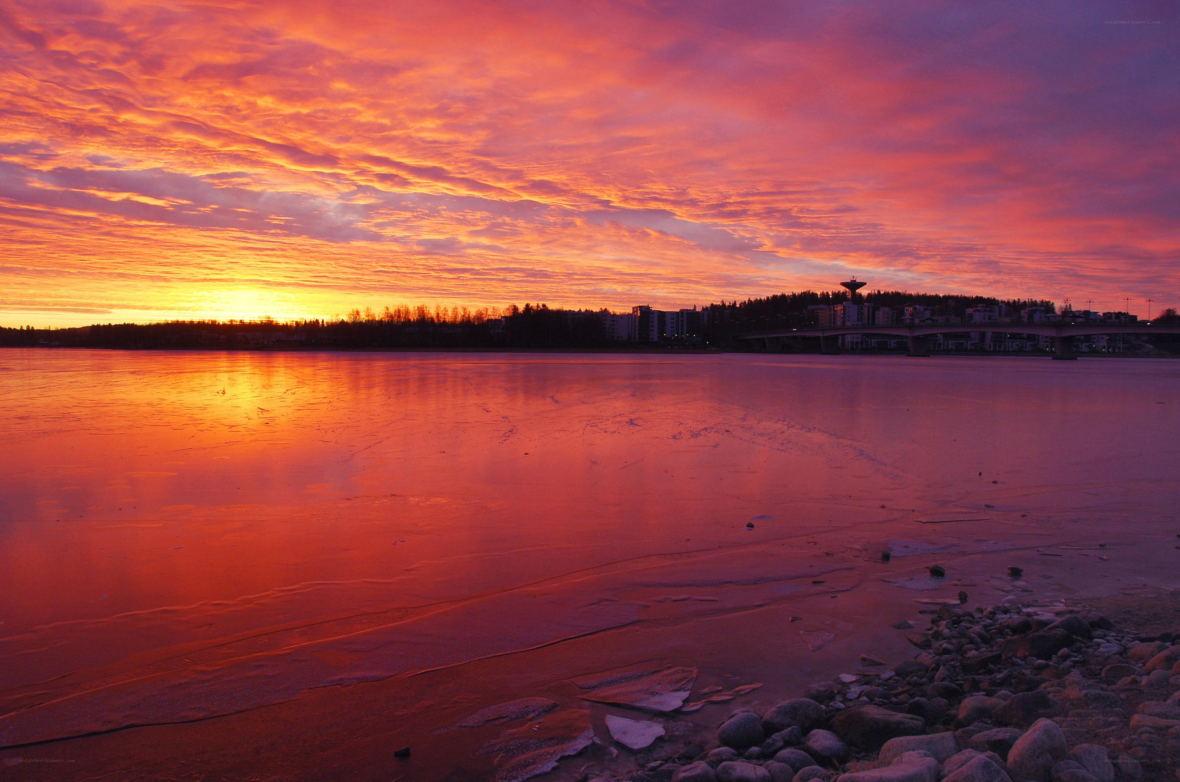 Vibrant sunset over frozen river