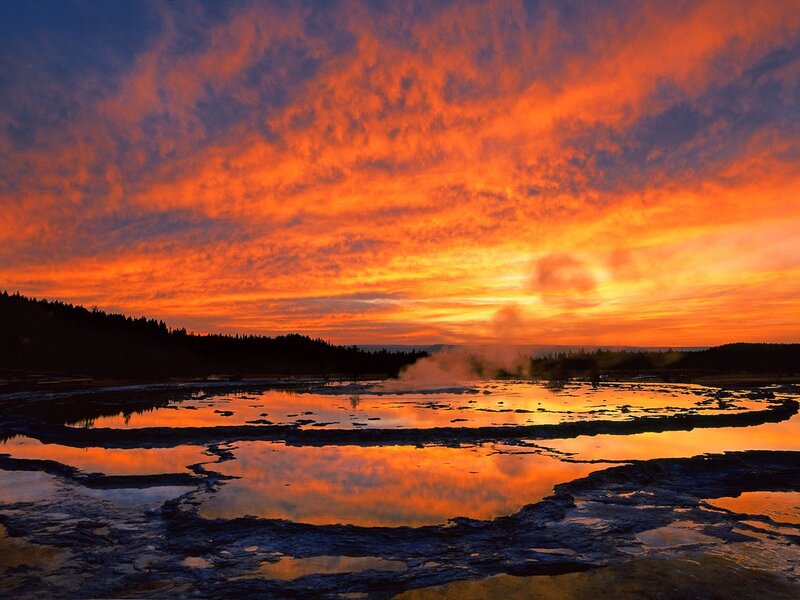 Vibrant sunset over geothermal pools