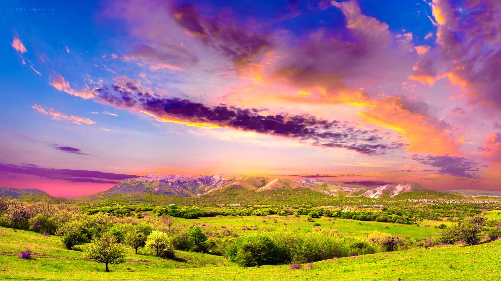 Vibrant sunset over green hills
