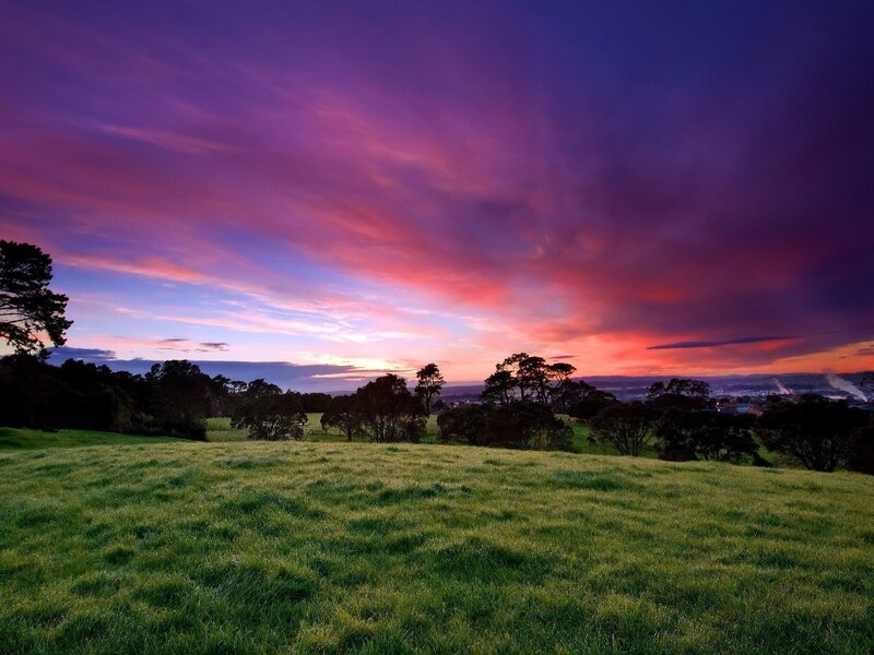 Vibrant sunset over green hills