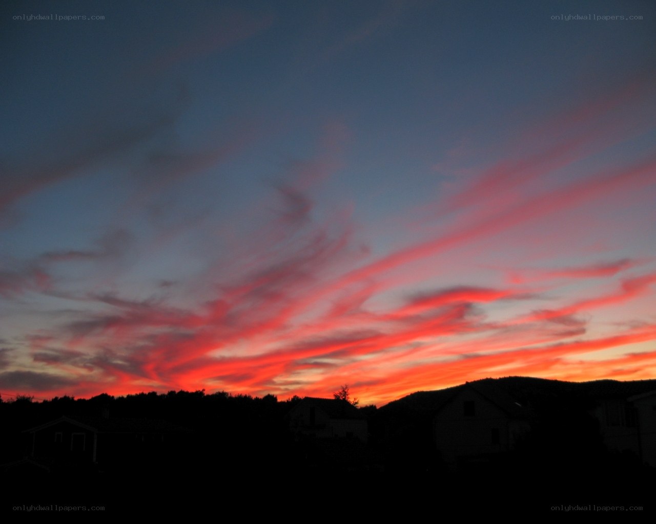 vibrant sunset over houses